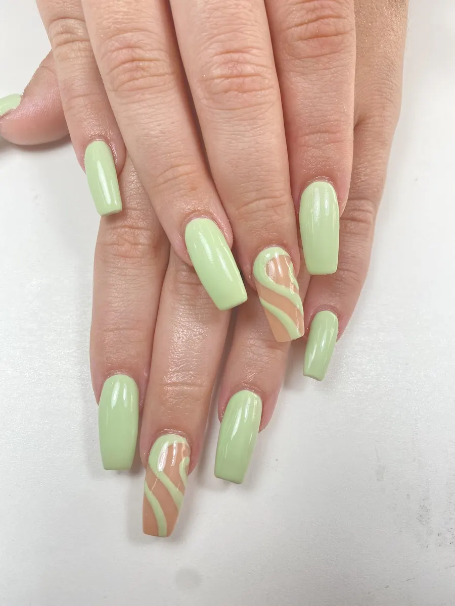 Sage green coffin nails with a swirl accent