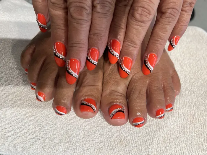 Red pedicure with rhinestone accents