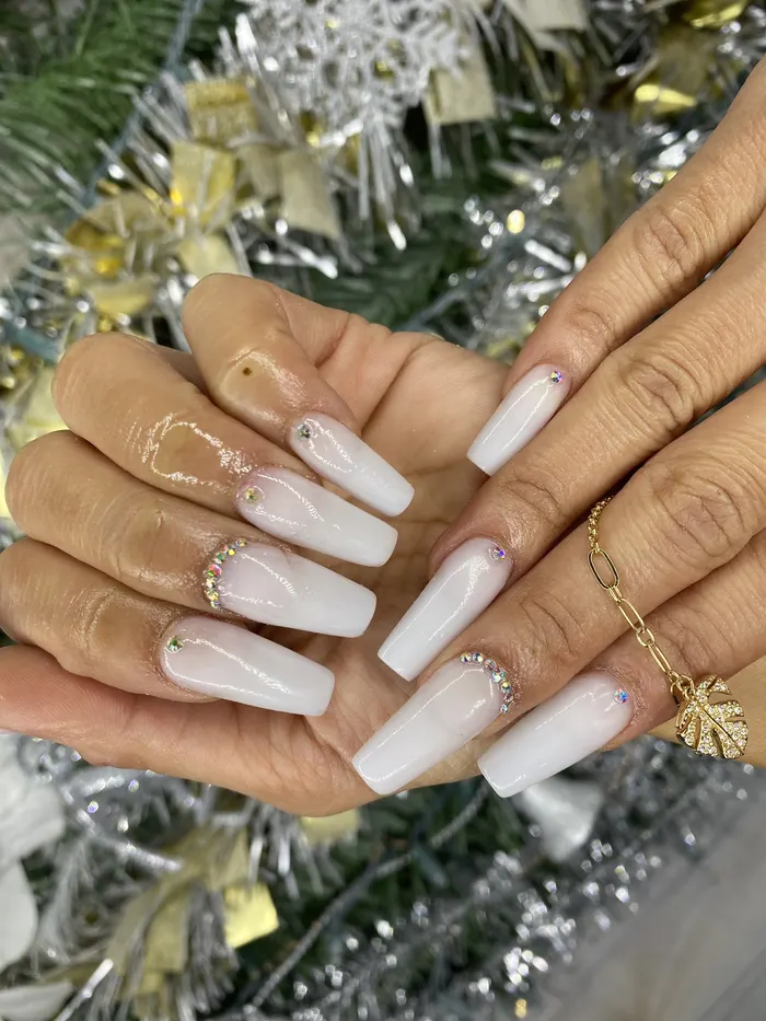 Long white nails with gold accents